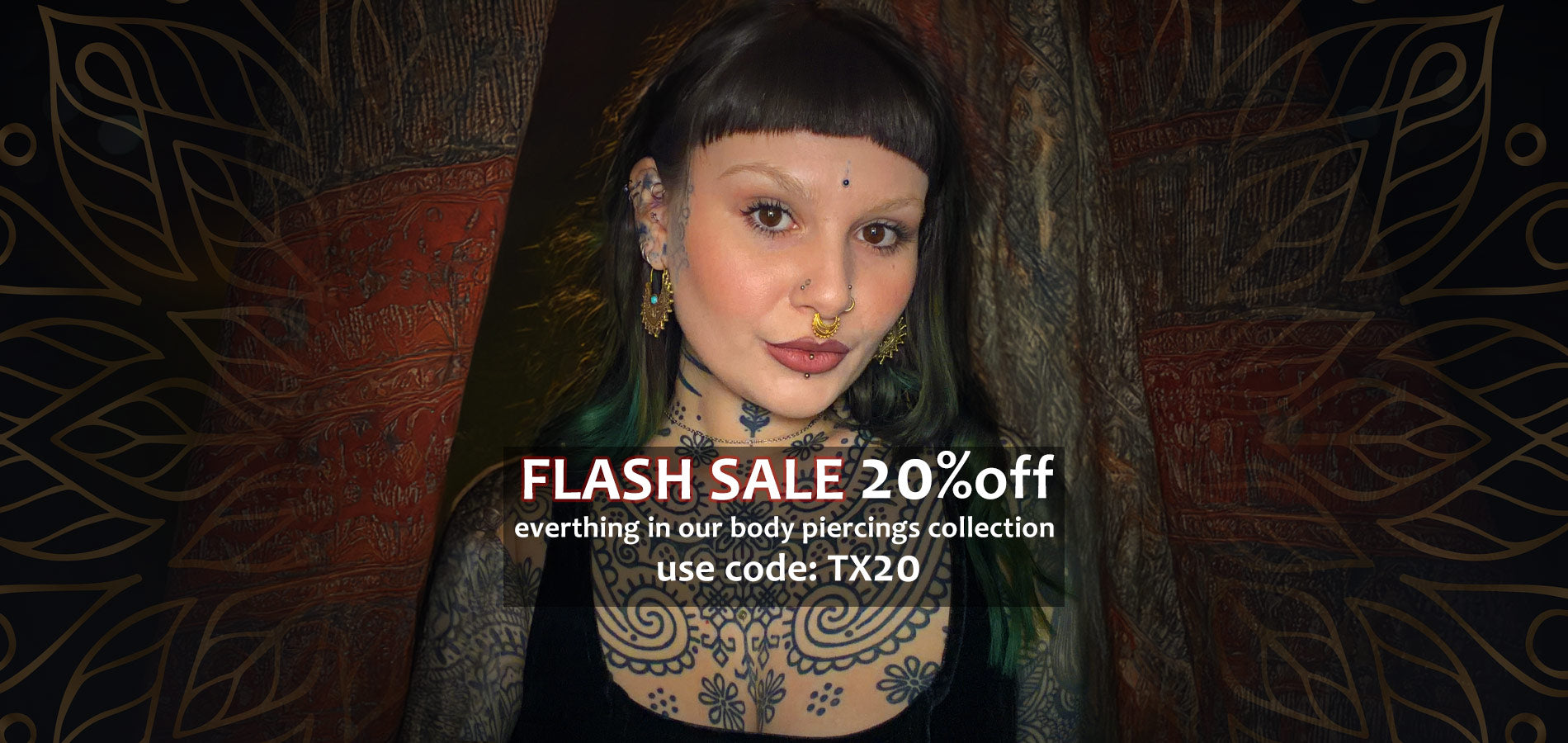 alternative woman with tattoos, tribal earrings and piercings standing in front of Indian drapes with sale text