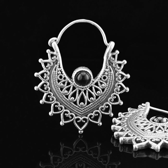 gypsy earrings in silver brass with heart mandala running around a teardrop set with a black onyx stone