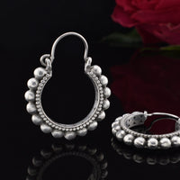 silver brass tribal hoop earrings with balls around the edge