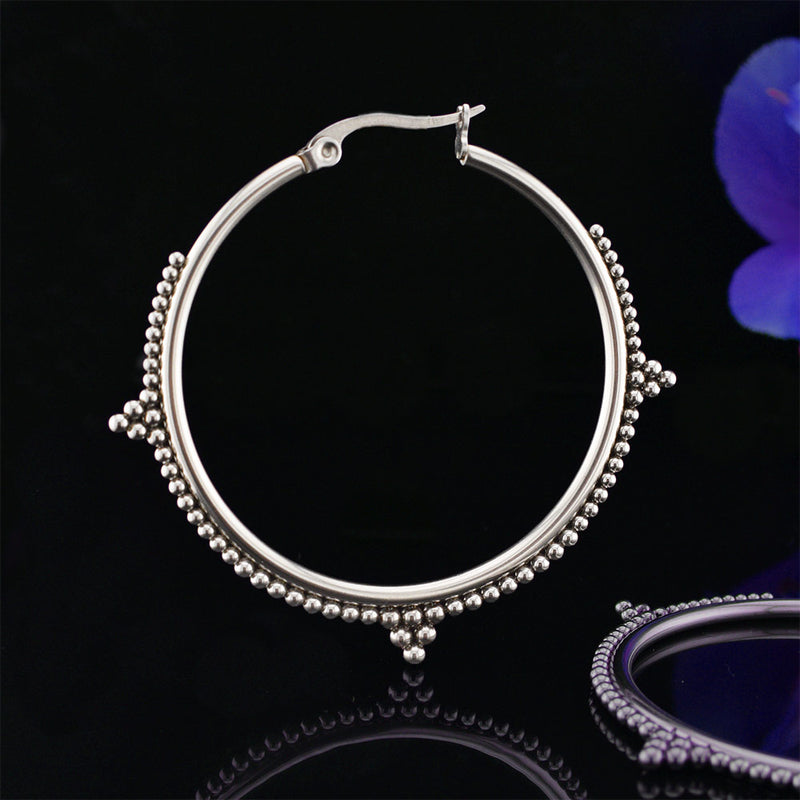 Steel hoop earrings with tribal beading 