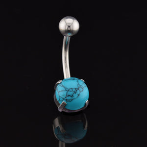 Belly button ring with turquoise stone on a black background