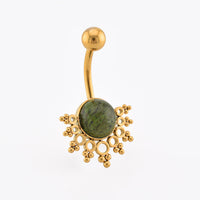 Gold-plated curved barbell belly button ring with a round green jade stone centerpiece and ornate gold filigree details, shown on a plain white background.