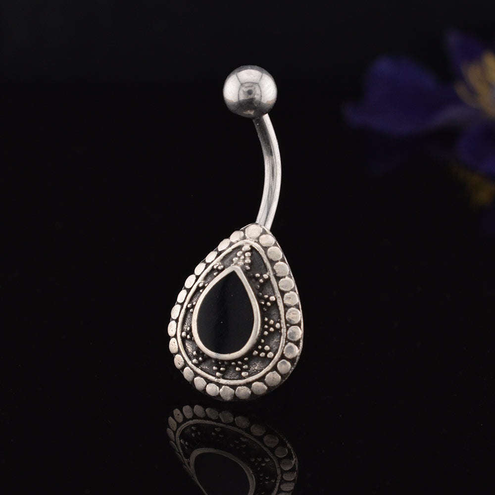 A silver ended curved barbell navel/ belly button ring with a teardrop-shaped shield featuring a black Onyx teardrop center and a border of small silver dots, shown on a plain white background.