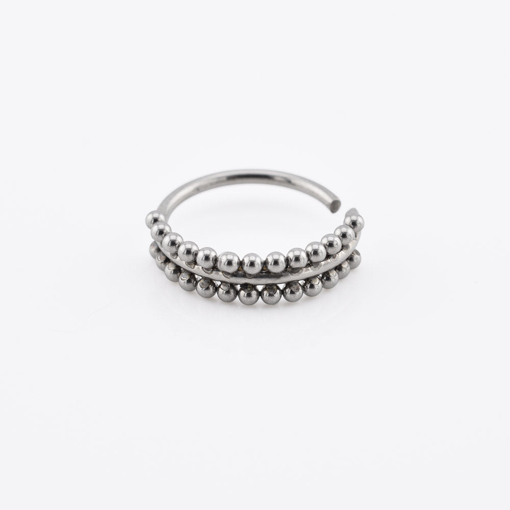 Silver steel beaded nose ring on a white background