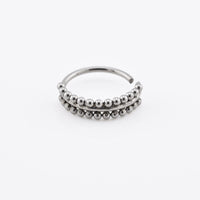Silver steel beaded nose ring on a white background