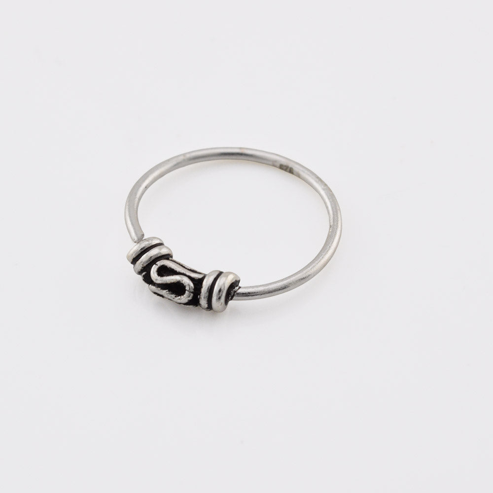 Bali silver nose ring on a white background