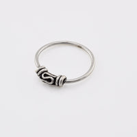 Bali silver nose ring on a white background