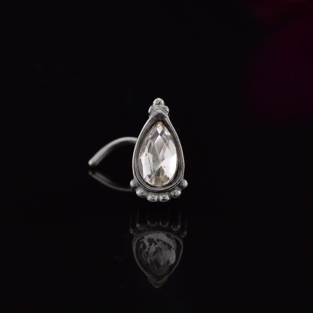 Indian nose stud with teardrop crystal decorated with tribal beads on black background