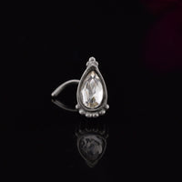 Indian nose stud with teardrop crystal decorated with tribal beads on black background
