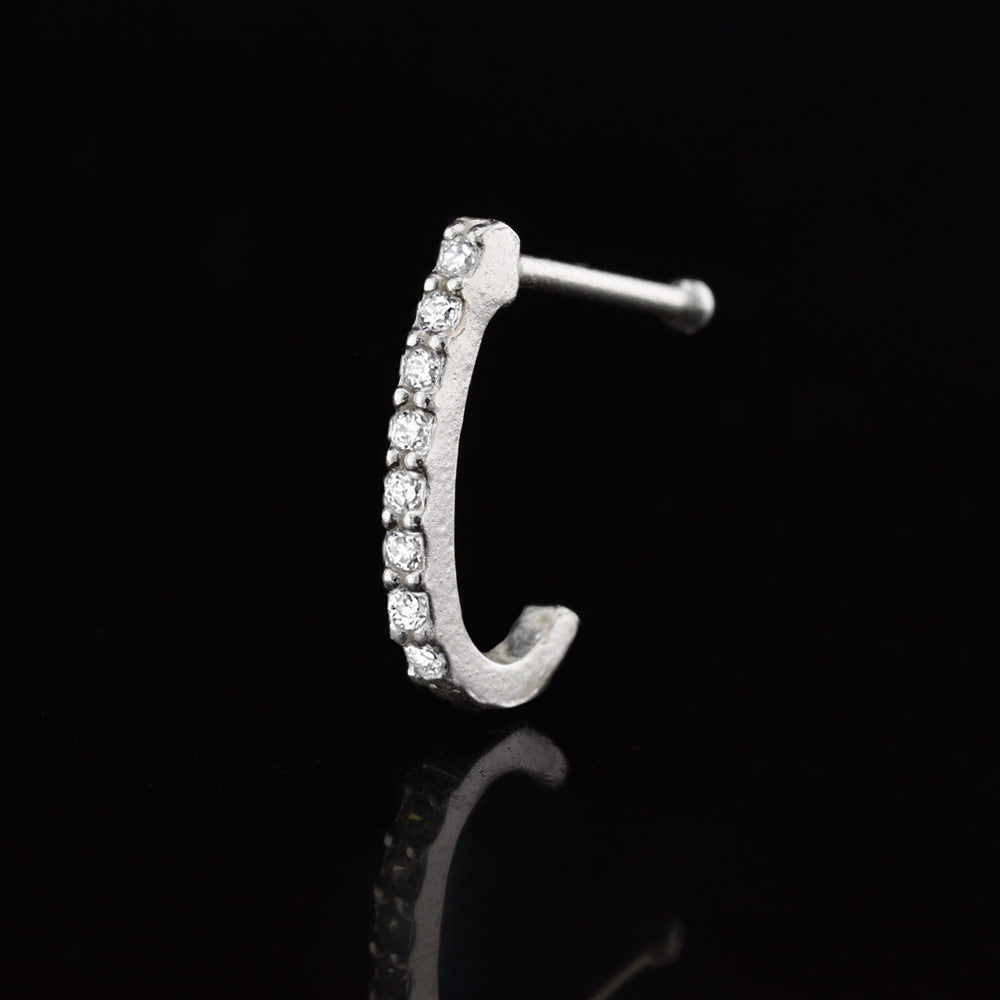 silver nose curve with crystal gems on a black reflective background