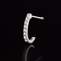 silver nose curve with crystal gems on a black reflective background