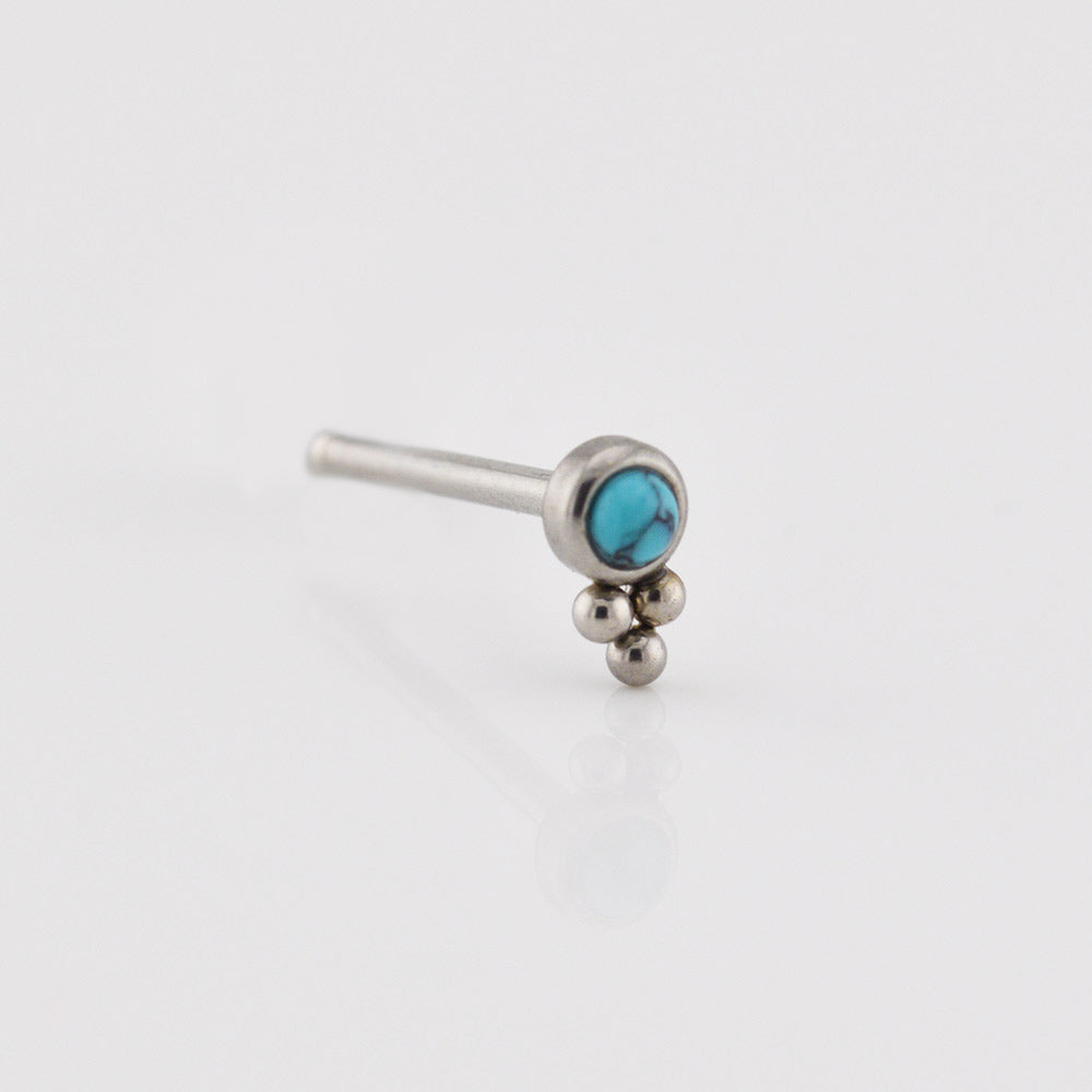 Silver nose ring with turquoise stone on a white background