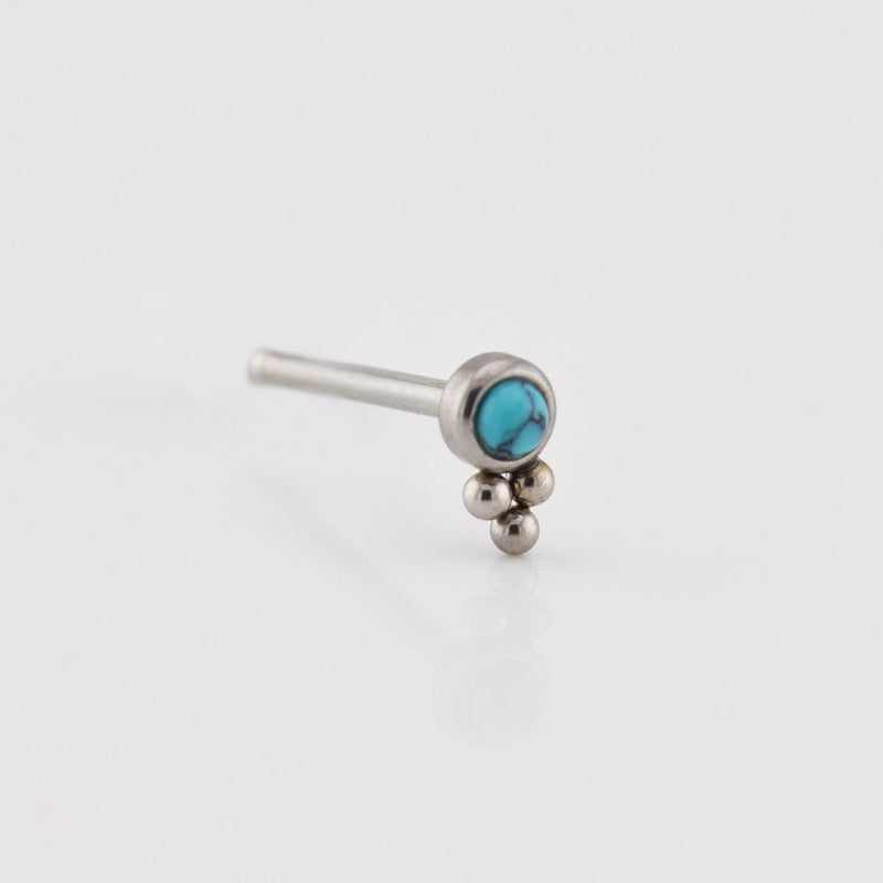 Silver nose ring with turquoise stone on a white background