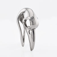crow skull ear hanger on a white background