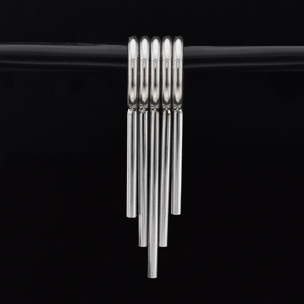 set of 5 clicker rings with drop spikes for wearing in stretched ears in surgical steel on a black background