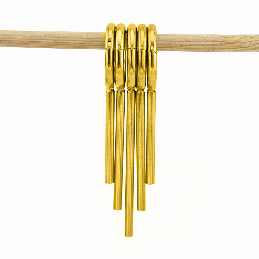 Stack of 5 gold coloured clicker rings with drop spikes for wearing in stretched ears on a white background