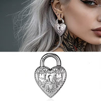 woman wearing gothic ear weights in the shape of a heart padlock with bats and another image of the padlock ear weight on a white background