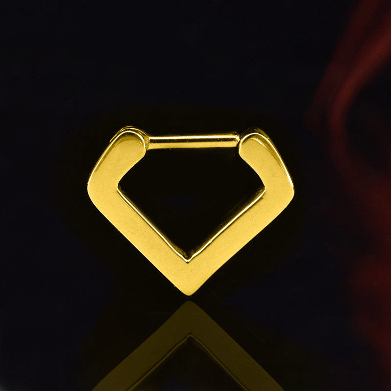 V shape septum ring in gold steel on a black reflective background