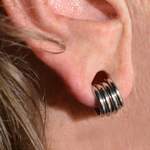 stacking rings in stretched ear lobe