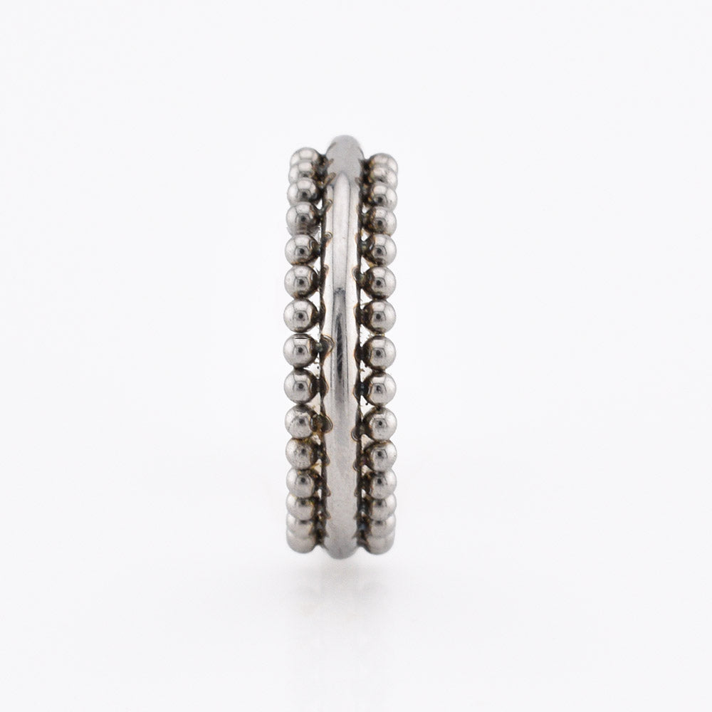 A surgical steel triple-band hinged segment clicker ring featuring one smooth band and two beaded bands, displayed on a plain white background