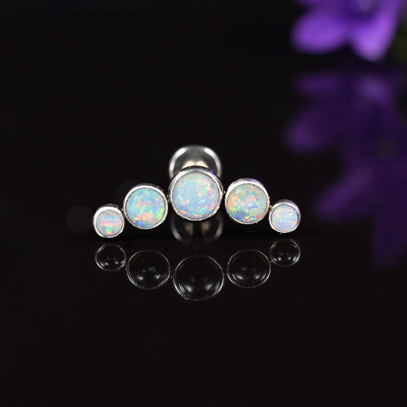 helix earring, labret with 5 opal stones on a black background