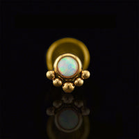 Flatback earring labret stud in gold steel with tribal beads and opal stone on a black reflective background