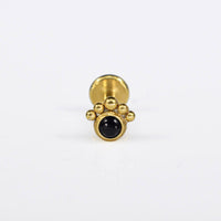 black stone labret in gold steel with curve of tribal dots
