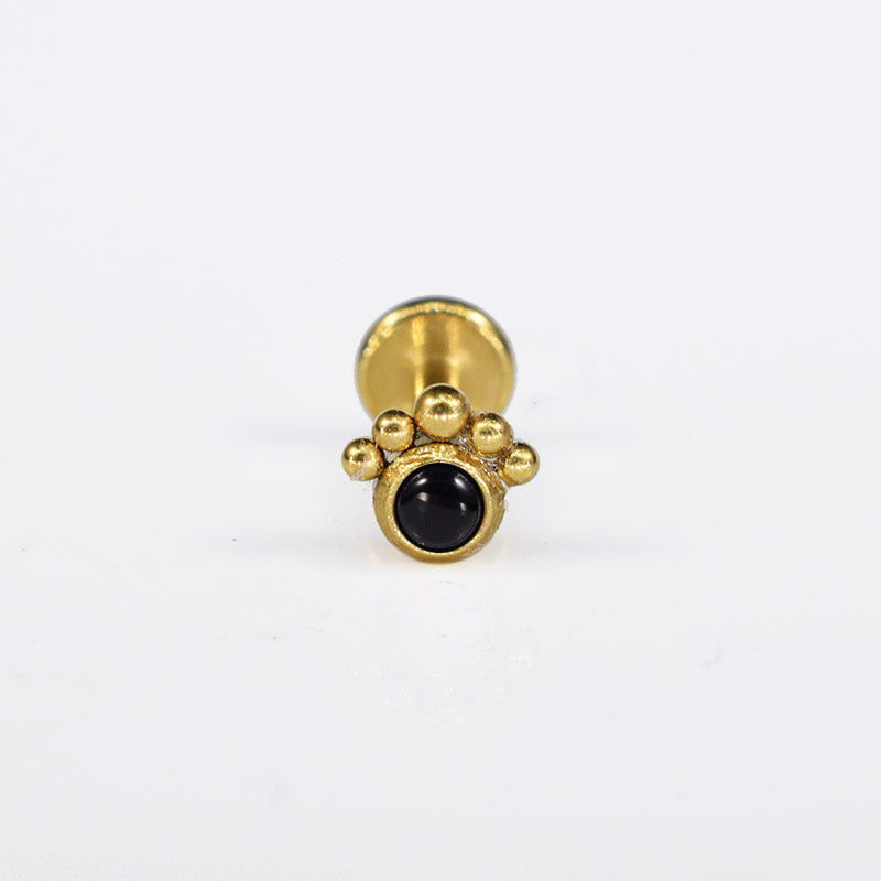 black stone labret in gold steel with curve of tribal dots

