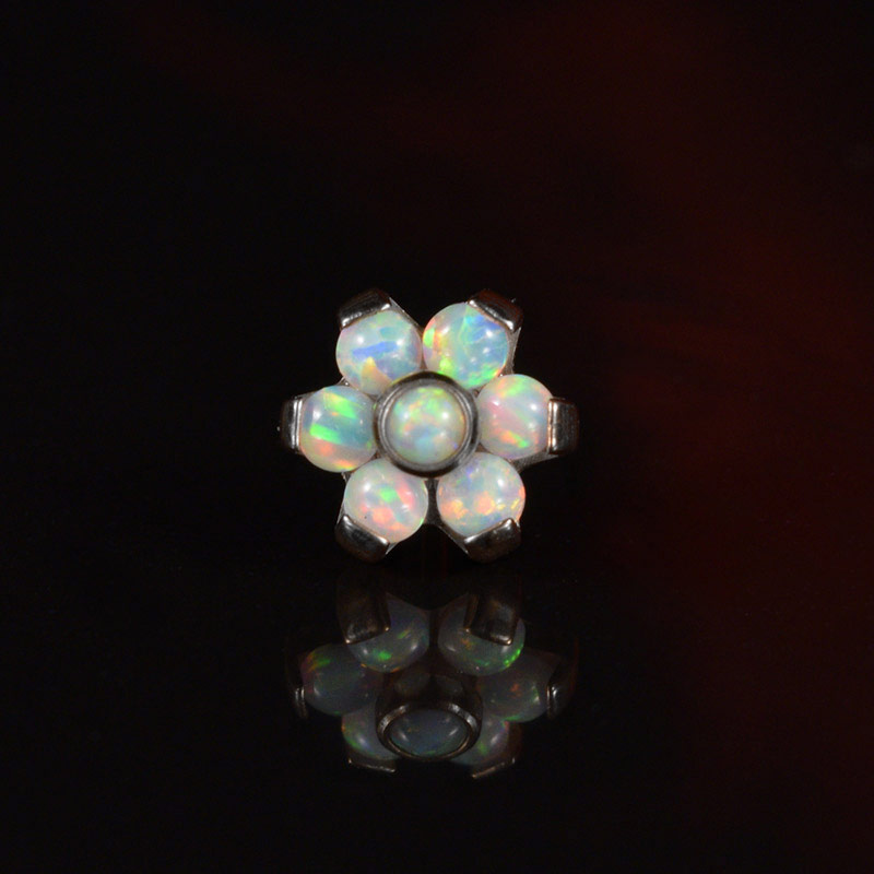 Threadless Labret in Titanium with 6 opal stones on ablack background