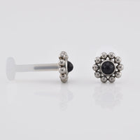 Bioflex PTFE labret with a black onyx stone surrounded by tribal beading on a white background