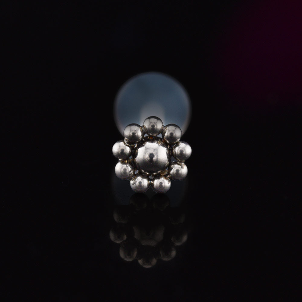 BioFlex PTFE labret stud with tribal dotdesign on a balck background