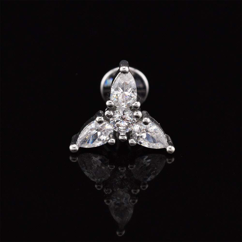 A silver-tone triquetra cluster labret stud earring featuring three marquise-cut clear stones and a round center stone, displayed on a reflective black surface.