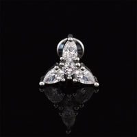 A silver-tone triquetra cluster labret stud earring featuring three marquise-cut clear stones and a round center stone, displayed on a reflective black surface.
