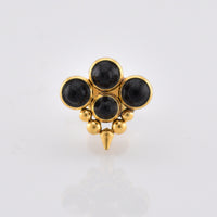 gold steel labret stud jewellery with four black onyx stones, tribal beads and a drop spike on a white background
