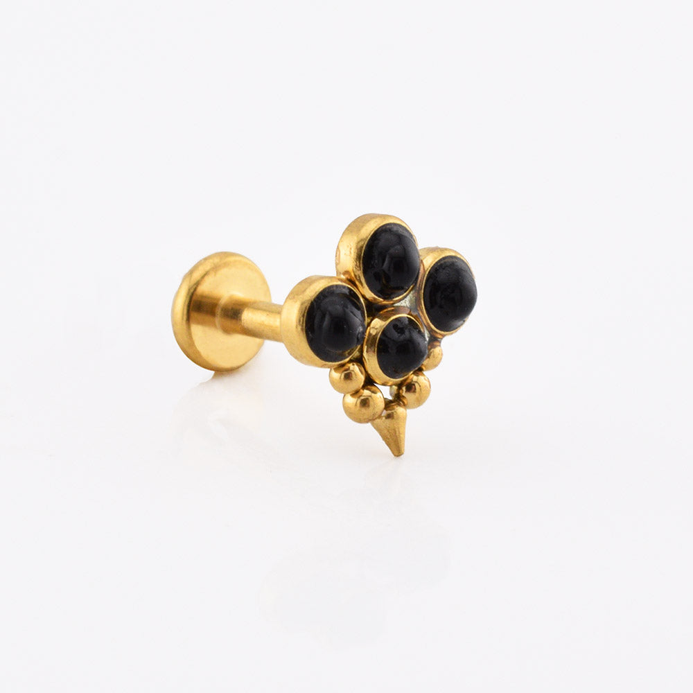 A gold-colored labret stud earring featuring a cluster of five black onyx cabochons and a small pointed spike at the bottom, shown on a clean white background.