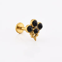 A gold-colored labret stud earring featuring a cluster of five black onyx cabochons and a small pointed spike at the bottom, shown on a clean white background.