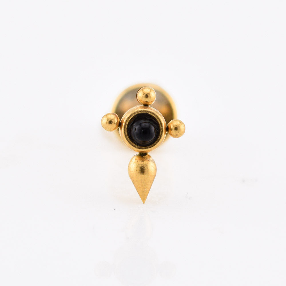 A gold-tonedlabret piercing stud with a central black oval stone, three small gold beads on the sides, and a teardrop-shaped drop below, shown on a plain white background.