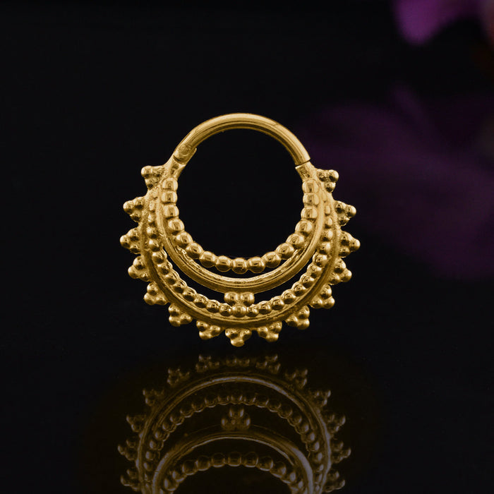 gold clicker ring in a tribal indian design, surgical steel hinged segment ring