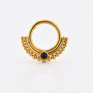 tribal indian hinged segment clicker ring in gold steel with black onyx stone on white background