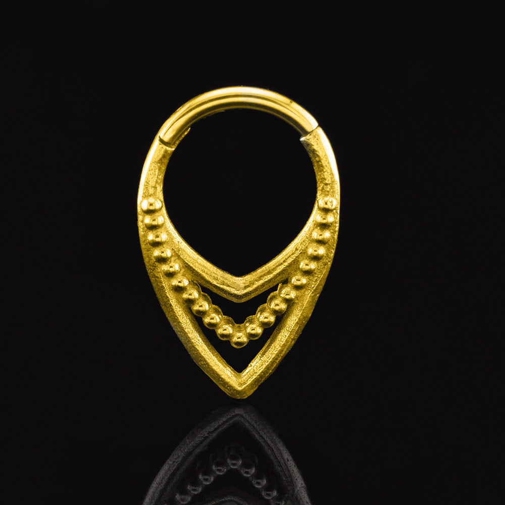 Tribal Triple V shape clicker ring in gold surgical steel on a black background