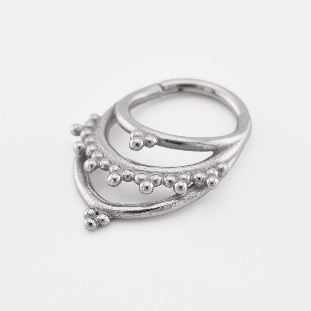 Tribal Clicker RIng aka hinged segment piercing ring with triple hoops and tribal dots in an Indian design on a white background