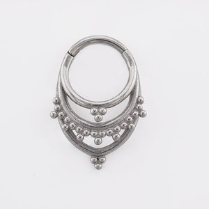 Tribal Clicker RIng aka hinged segment piercing ring in an Indian design on a white background