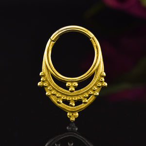 Indian Tribal Segment Clicker Ring in Gold Steel on a black backgound