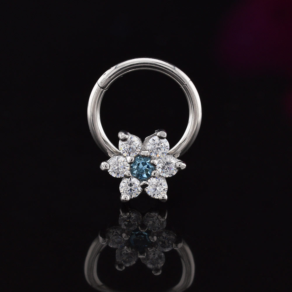 hinged segment earring with flower design in CZ crystals on a black reflective surface