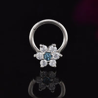 hinged segment earring with flower design in CZ crystals on a black reflective surface