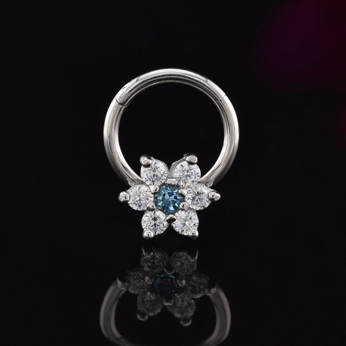 hinged segment earring with flower design in CZ crystals on a black reflective surface