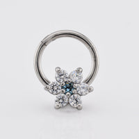 hinged segment clicker earring with flower design in CZ crystals on a white background