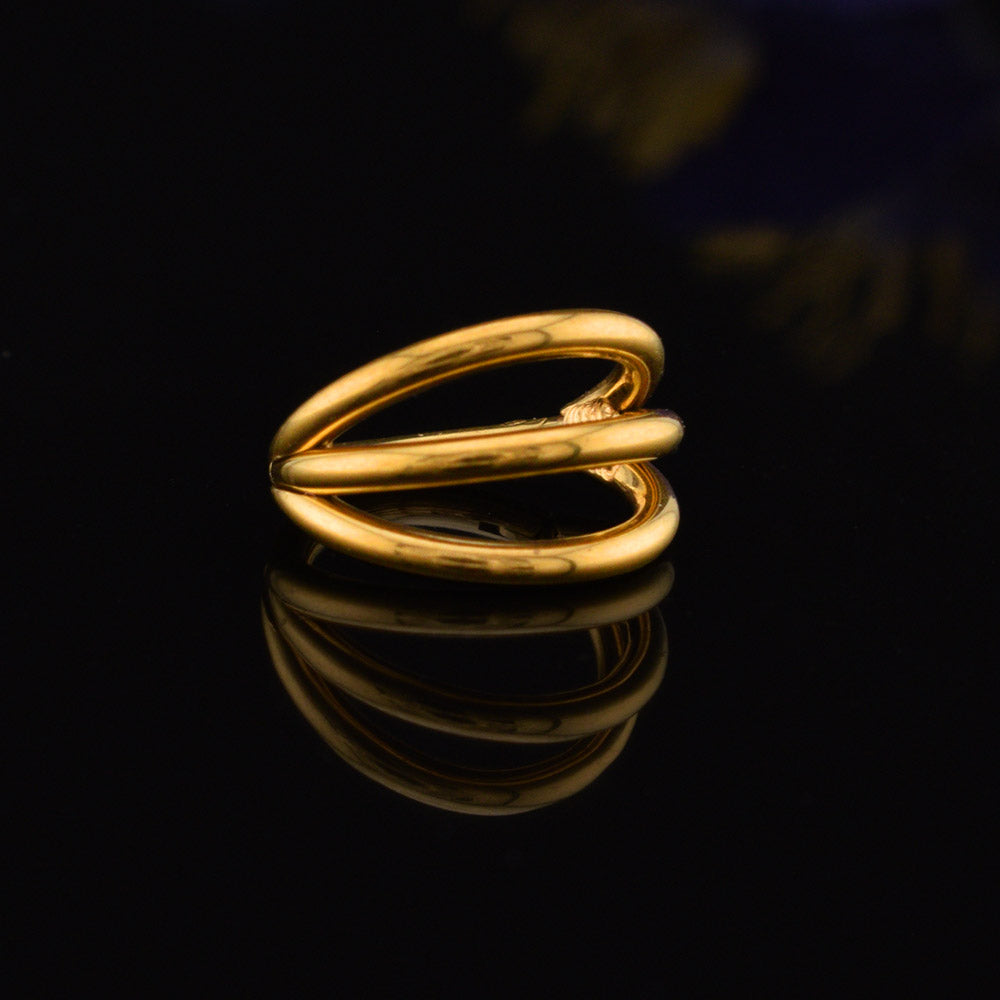 triple stack segment clicker ring in gold steel on a black reflective background