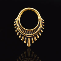 clicker ring for septum and ear piercings, a boho art deco design in gold surgical steel on a black reflective background
