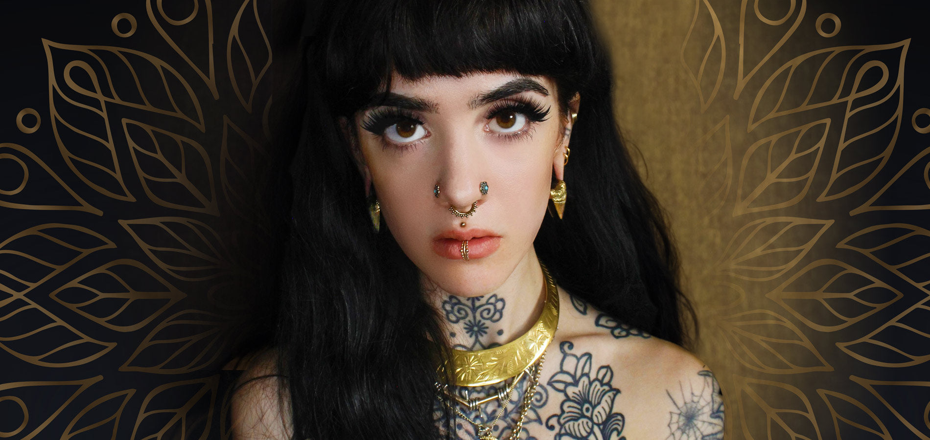 alternative woman with tattoos, tribal nose studs, septum and labret piercing jewellery and stretched ears with ear weights